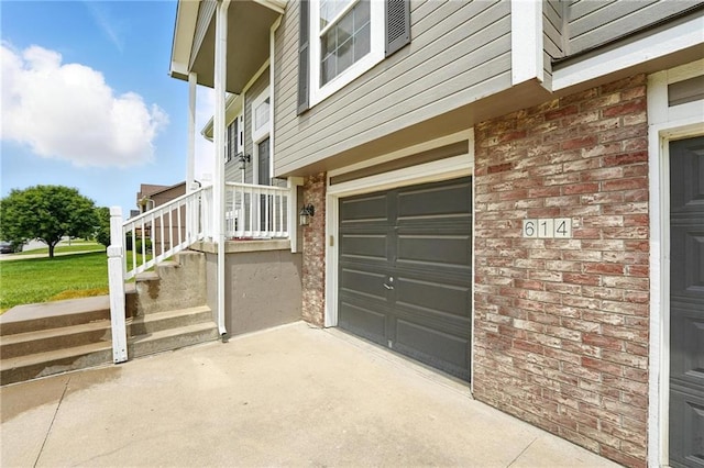 614 SW Tisha Ln, Grain Valley, MO 64029 - view of side of property featuring a garage, brick siding, and concrete driveway
