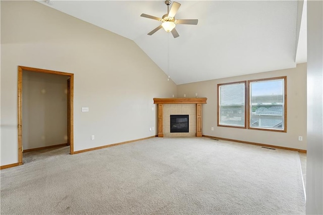 614 SW Tisha Ln, Grain Valley, MO 64029 - unfurnished living room with a tiled fireplace, a ceiling fan, light colored carpet, and high vaulted ceiling