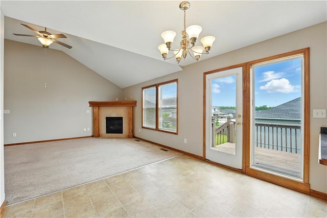 614 SW Tisha Ln, Grain Valley, MO 64029 - unfurnished living room featuring lofted ceiling, a fireplace, a chandelier, ceiling fan, and light colored carpet