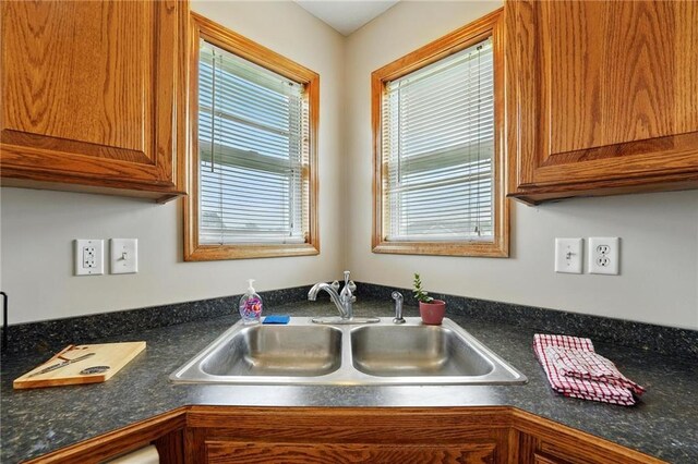 614 SW Tisha Ln, Grain Valley, MO 64029 - kitchen view of brown cabinets and dark countertops