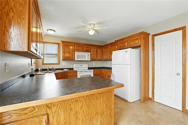 614 SW Tisha Ln, Grain Valley, MO 64029 - kitchen with white appliances, a peninsula, ceiling fan, dark countertops, and brown cabinetry