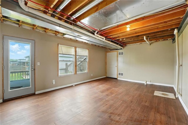 614 SW Tisha Ln, Grain Valley, MO 64029 - below grade area featuring wood finished floors
