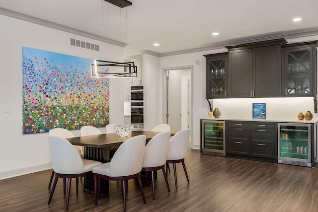 400 W 49th Ter Unit 2106, Kansas City, MO 64112 - dining space with beverage cooler, a bar, dark wood-type flooring, baseboards, and recessed lighting