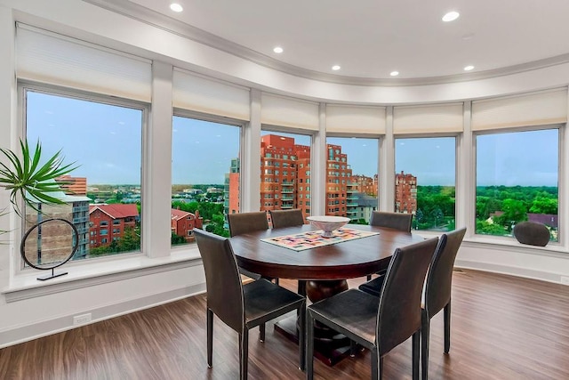 400 W 49th Ter Unit 2106, Kansas City, MO 64112 - dining space with wood finished floors, recessed lighting, baseboards, ornamental molding, and a city view