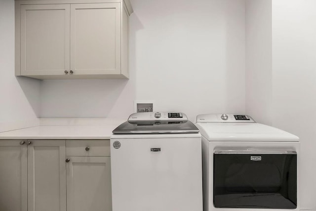 400 W 49th Ter Unit 2106, Kansas City, MO 64112 - laundry area with cabinet space and washing machine and dryer