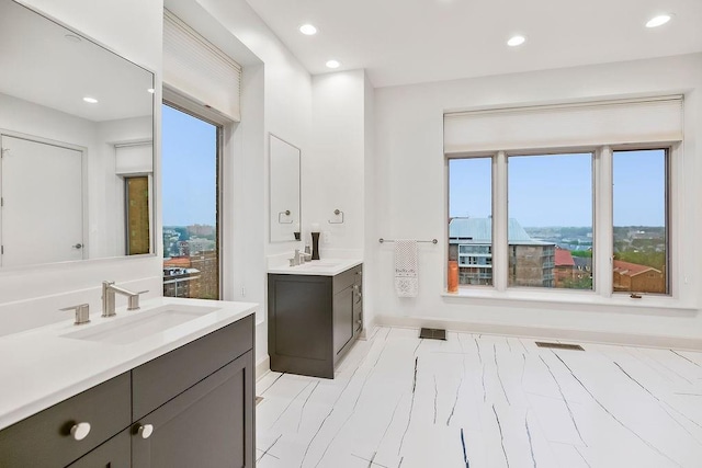 400 W 49th Ter Unit 2106, Kansas City, MO 64112 - bathroom featuring two vanities, recessed lighting, and baseboards