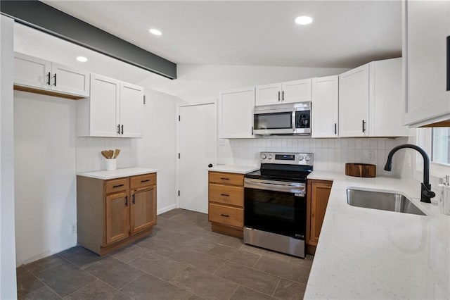 3523 Drumm Ave, Independence, MO 64055 - kitchen with stainless steel appliances, a sink, tasteful backsplash, white cabinets, and recessed lighting