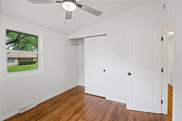 3523 Drumm Ave, Independence, MO 64055 - unfurnished bedroom with lofted ceiling, a closet, wood finished floors, baseboards, and ceiling fan