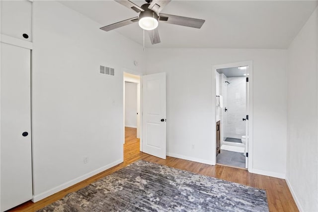 3523 Drumm Ave, Independence, MO 64055 - unfurnished bedroom with lofted ceiling, wood finished floors, baseboards, ensuite bath, and ceiling fan