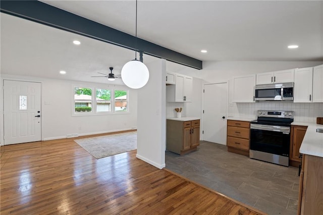 3523 Drumm Ave, Independence, MO 64055 - kitchen featuring stainless steel appliances, dark wood-type flooring, tasteful backsplash, a ceiling fan, and light countertops