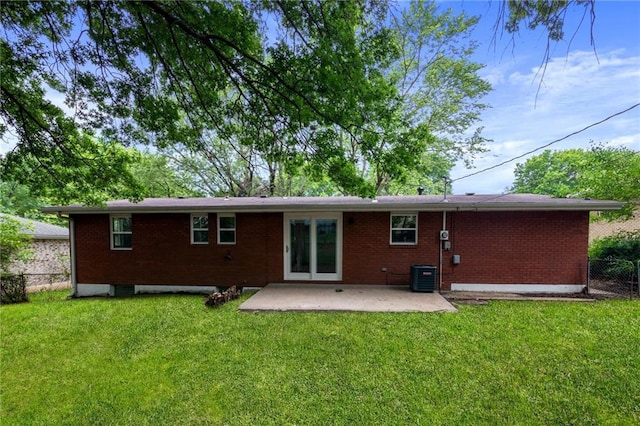 3523 Drumm Ave, Independence, MO 64055 - back of house featuring a patio area, brick siding, and central AC
