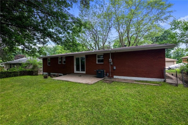 3523 Drumm Ave, Independence, MO 64055 - back of property featuring a patio area, central AC, and brick siding
