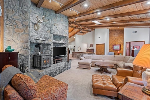 19913 Pepper Tree Rd, Edgerton, KS 66021 - living area featuring a wood ceiling with exposed beams, carpet flooring, and a wood stove
