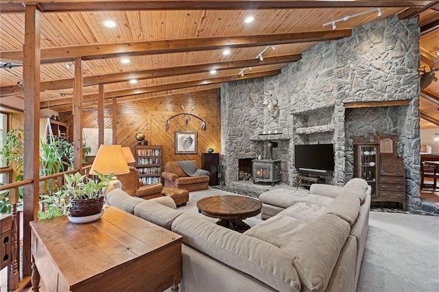 19913 Pepper Tree Rd, Edgerton, KS 66021 - carpeted living room with wood ceiling, a wood stove, and wood walls