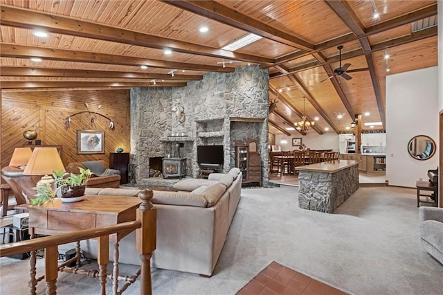 19913 Pepper Tree Rd, Edgerton, KS 66021 - living room featuring a wood ceiling with exposed beams, ceiling fan, carpet floors, and a wood stove