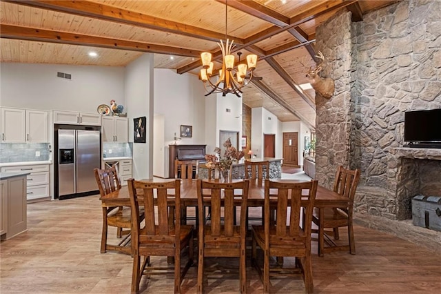 19913 Pepper Tree Rd, Edgerton, KS 66021 - dining room with a wood ceiling with exposed beams, a towering ceiling, light wood-type flooring, and a chandelier