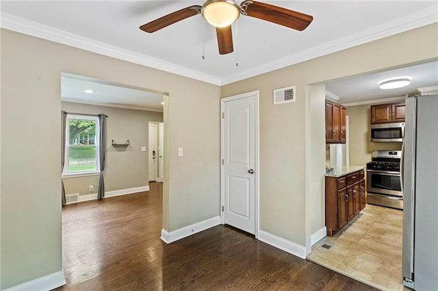 8424 Ward Parkway Plz, Kansas City, MO 64114 - kitchen featuring stainless steel appliances, wood finished floors, crown molding, ceiling fan, and light stone counters