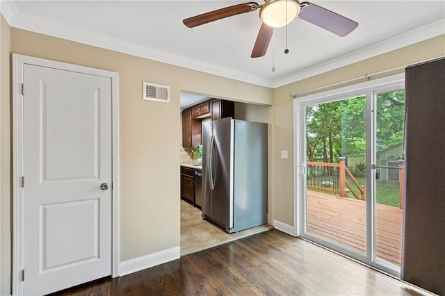 8424 Ward Parkway Plz, Kansas City, MO 64114 - kitchen featuring stainless steel appliances, crown molding, wood finished floors, light countertops, and dark brown cabinetry