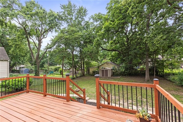 8424 Ward Parkway Plz, Kansas City, MO 64114 - wooden terrace with a storage shed, a playground, a fenced backyard, and view of wooded area