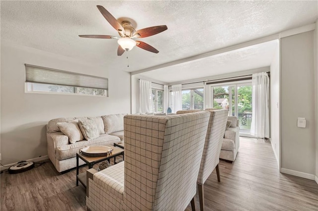 37 Beach Dr, Blue Springs, MO 64015 - living area with a textured ceiling, wood finished floors, ceiling fan, and baseboards