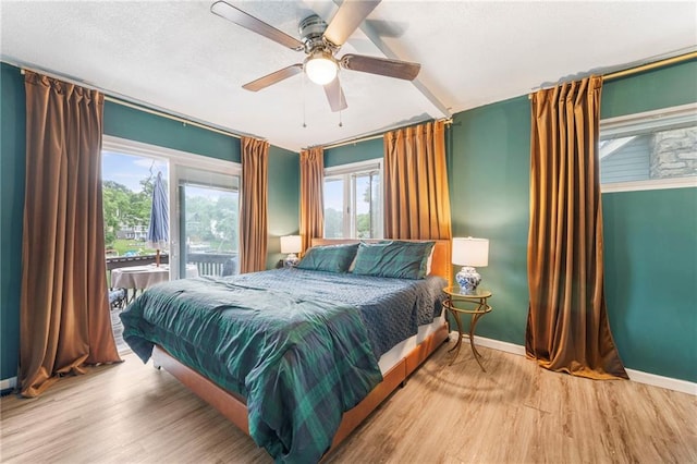 37 Beach Dr, Blue Springs, MO 64015 - bedroom featuring access to exterior, wood finished floors, baseboards, and ceiling fan