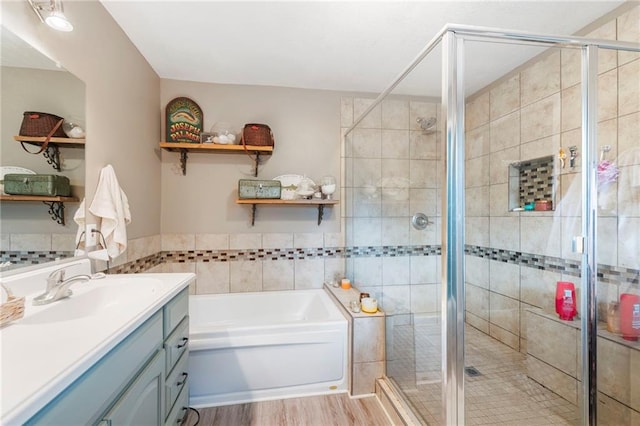 37 Beach Dr, Blue Springs, MO 64015 - bathroom featuring vanity, a garden tub, a stall shower, wood finished floors, and tile walls
