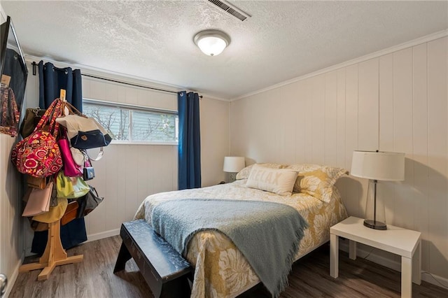 37 Beach Dr, Blue Springs, MO 64015 - bedroom featuring wood finished floors, a textured ceiling, and ornamental molding