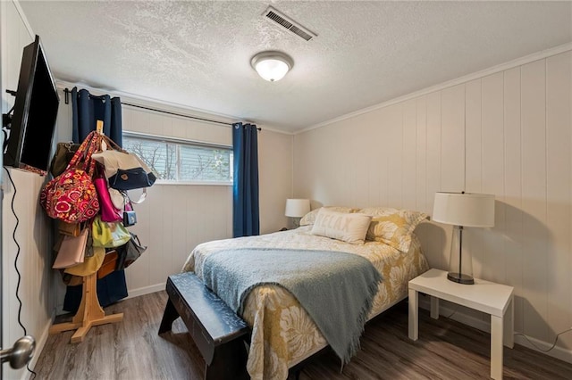 37 Beach Dr, Blue Springs, MO 64015 - bedroom with wood finished floors, a textured ceiling, and crown molding
