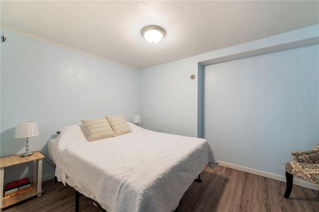 37 Beach Dr, Blue Springs, MO 64015 - bedroom with wood finished floors, baseboards, a textured ceiling, and ornamental molding