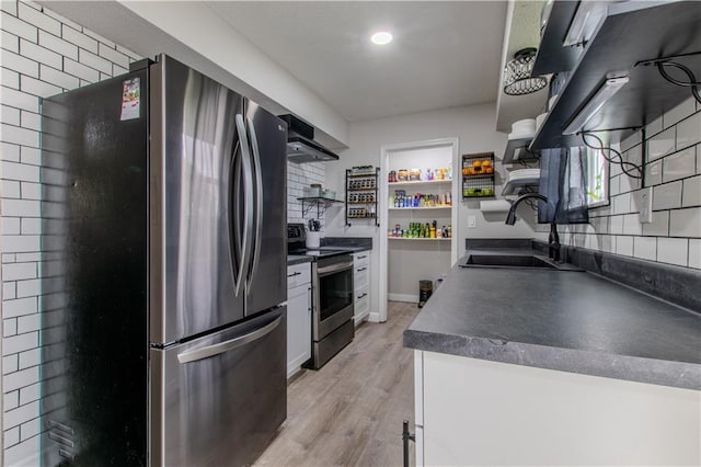 604 Lake Rd, Garden City, MO 64747 - kitchen featuring stainless steel appliances, open shelves, dark countertops, a sink, and wall chimney exhaust hood