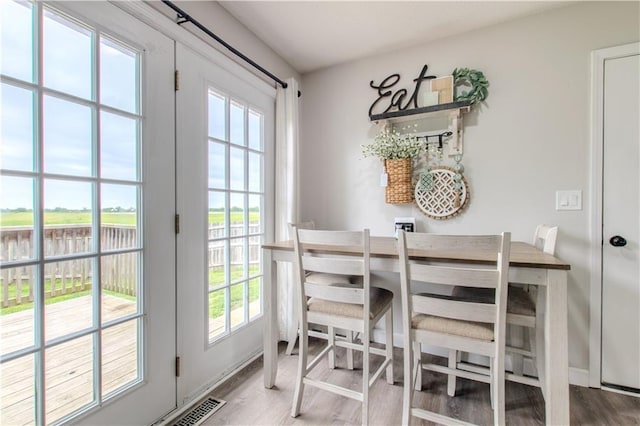 604 Lake Rd, Garden City, MO 64747 - dining room with wood finished floors and a water view