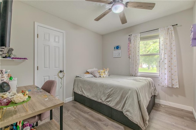 604 Lake Rd, Garden City, MO 64747 - bedroom with light wood-style flooring, baseboards, and a ceiling fan