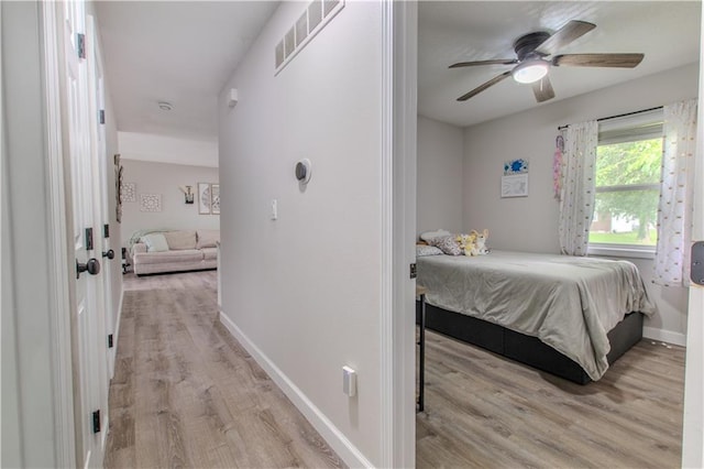 604 Lake Rd, Garden City, MO 64747 - bedroom with light wood finished floors, baseboards, and ceiling fan