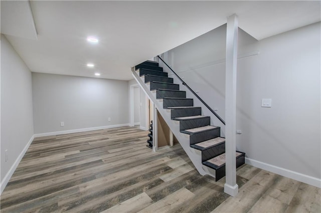 604 Lake Rd, Garden City, MO 64747 - finished below grade area featuring stairway, wood finished floors, recessed lighting, and baseboards