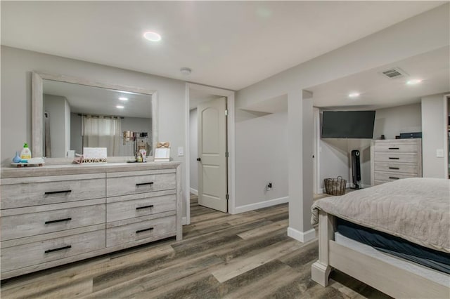 604 Lake Rd, Garden City, MO 64747 - bedroom with wood finished floors, baseboards, and recessed lighting