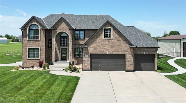 19108 Autumn Ln, Pleasant Hill, MO 64080 - view of front facade featuring a front yard, concrete driveway, brick siding, and roof with shingles