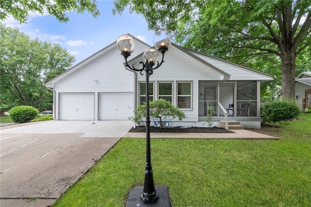 16000 E 28th St S, Independence, MO 64055 - single story home featuring a sunroom, a garage, driveway, and a front yard