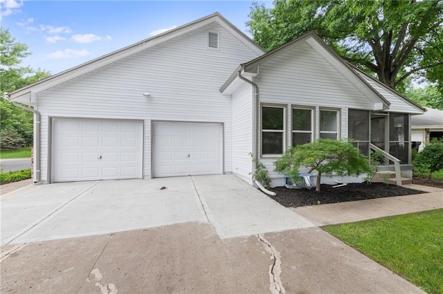 16000 E 28th St S, Independence, MO 64055 - ranch-style home with a sunroom, concrete driveway, and an attached garage