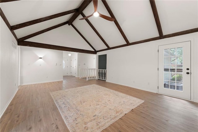 16000 E 28th St S, Independence, MO 64055 - unfurnished living room featuring a ceiling fan, beamed ceiling, high vaulted ceiling, light wood finished floors, and baseboards
