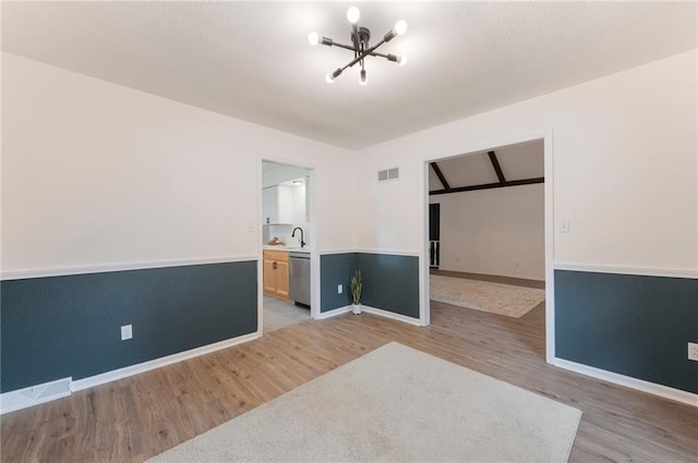 16000 E 28th St S, Independence, MO 64055 - unfurnished room with light wood finished floors, baseboards, a chandelier, and a sink
