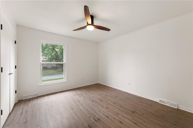 16000 E 28th St S, Independence, MO 64055 - empty room featuring wood finished floors, a ceiling fan, and baseboards