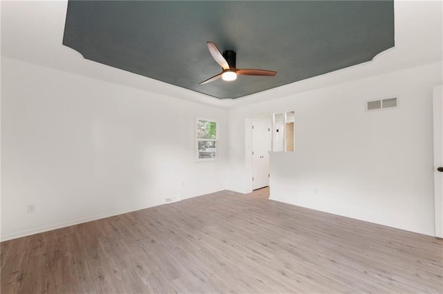 16000 E 28th St S, Independence, MO 64055 - unfurnished room with a ceiling fan, light wood-style flooring, and a raised ceiling