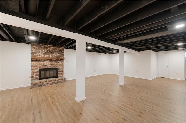 16000 E 28th St S, Independence, MO 64055 - finished below grade area with wood finished floors, baseboards, and a brick fireplace
