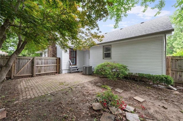 16000 E 28th St S, Independence, MO 64055 - rear view of house featuring a fenced backyard, a patio, central air condition unit, a gate, and roof with shingles