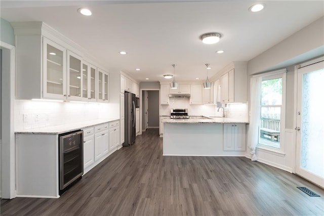 10246 Russell St, Overland Park, KS 66212 - kitchen with beverage cooler, freestanding refrigerator, white cabinets, dark wood-style floors, and recessed lighting