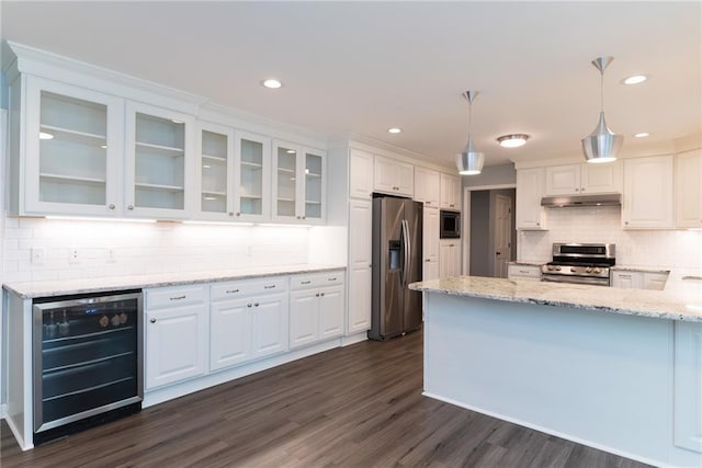 10246 Russell St, Overland Park, KS 66212 - kitchen with stainless steel appliances, beverage cooler, under cabinet range hood, white cabinets, and recessed lighting