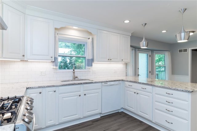 10246 Russell St, Overland Park, KS 66212 - kitchen with dishwasher, stainless steel gas range oven, a peninsula, white cabinetry, and decorative backsplash