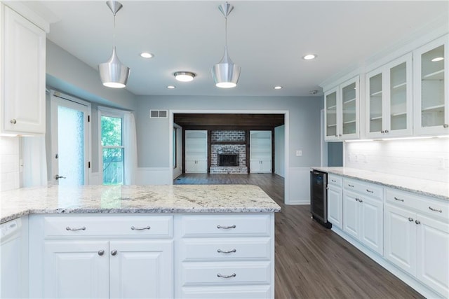 10246 Russell St, Overland Park, KS 66212 - kitchen featuring beverage cooler, white cabinetry, glass insert cabinets, tasteful backsplash, and dark wood finished floors