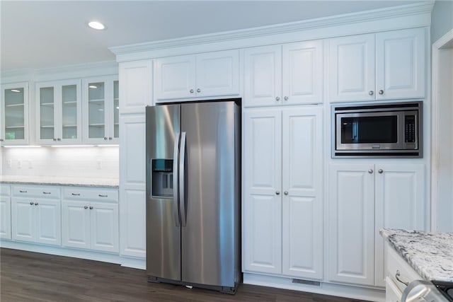 10246 Russell St, Overland Park, KS 66212 - kitchen with appliances with stainless steel finishes, white cabinets, glass insert cabinets, light stone countertops, and recessed lighting