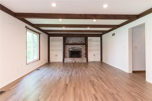 10246 Russell St, Overland Park, KS 66212 - unfurnished living room with wood finished floors, a fireplace, recessed lighting, and beamed ceiling